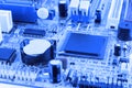 Integrated semiconductor microchip microprocessor on blue circuit board representative of the high tech industry and computer scie Royalty Free Stock Photo