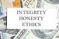 INTEGRITY HONESTY ETHICS text, a word written on a white business card against a background of money Royalty Free Stock Photo