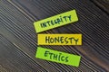 Integrity, Honesty, Ethics write on sticky notes isolated on Wooden Table Royalty Free Stock Photo