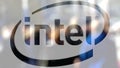 Intel Corporation logo on a glass against blurred crowd on the steet. Editorial 3D rendering