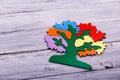 Multicolored tree for playing on the light wooden background. Royalty Free Stock Photo