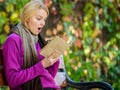 Intellectual hobby. Girl sit bench relaxing with book fall nature background. Lady bookworm read book outdoors fall day