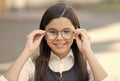 An intellectual look. Happy child look through glasses outdoors. Vision screening at school. Eye test. Corrective Royalty Free Stock Photo