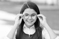 An intellectual look. Happy child look through glasses outdoors. Vision screening at school. Eye test. Corrective Royalty Free Stock Photo