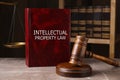 Intellectual Property law book and judge`s gavel on grey marble table Royalty Free Stock Photo