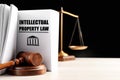 Intellectual Property law book, judge`s gavel and scales of justice on white table against background. Space for text Royalty Free Stock Photo