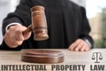 Intellectual property law. Judge with gavel at table, closeup Royalty Free Stock Photo