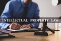 Intellectual property law. Jurist working at table in office, focus on gavel Royalty Free Stock Photo