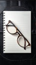 Intellectual Workspace with Glasses and Notepad Royalty Free Stock Photo