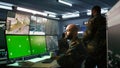 Intelligence corps expert controlling drones with mockup notebook