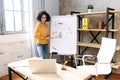 Smart black woman with whiteboard indoors Royalty Free Stock Photo