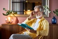 Intelligent mature man read book at home Royalty Free Stock Photo