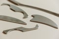 Intelligent stainless steel IASTM instruments for soft tissue massage and pain relief, the instruments lie on a beige