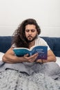 Intelligent young man holding a book on astrology Royalty Free Stock Photo