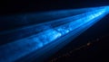 Bright blue light beams cutting through darkness with visible smoke or dust particles image Royalty Free Stock Photo
