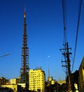 An intense blue sky with a distant moon rising. Royalty Free Stock Photo