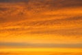 Intense colorful golden sky with layer of cloud at the evening before sunset Royalty Free Stock Photo