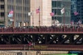 Intense crowd gathers on the MIchigan Avenue/DuSable Bridge over a dyed green Chicago River Royalty Free Stock Photo