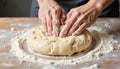 Intense hands kneading sticky dough on a floured surface, culinary art Royalty Free Stock Photo