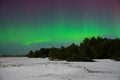 Intense northern lights aurora borealis over beach in Latvia