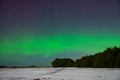 Intense northern lights aurora borealis over beach in Latvia