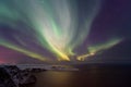 Intense northern lights, Aurora Borealis over Knivskjelloden Island, view from Nordkapp, North Cape, Norway