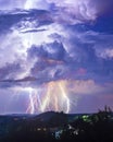 Intense thunderstome hitting with several lightning bolts in one place during night Royalty Free Stock Photo
