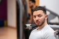 Intense young man at gym preparing for a workout. Royalty Free Stock Photo