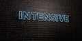 INTENSIVE -Realistic Neon Sign on Brick Wall background - 3D rendered royalty free stock image