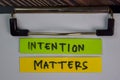 Intention Matters write on sticky notes isolated on Wooden Table Royalty Free Stock Photo