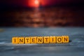 Intention on wooden blocks. Cross processed image with bokeh background Royalty Free Stock Photo