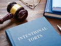 Intentional torts book with gavel as symbol of law. Royalty Free Stock Photo