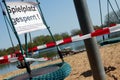 Intentionally crooked picture of sign with German inscription: Playground blocked at a playground equipment for children, concept
