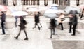 Intentionally motion blurred abstract image of commuters in a European city in a rainy day.