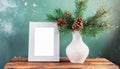 inter still life. Horizontal white frame mockup on vintage wooden bench, table. Modern white ceramic vase with pine tree branches Royalty Free Stock Photo