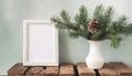 inter still life. Horizontal white frame mockup on vintage wooden bench, table. Modern white ceramic vase with pine tree branches Royalty Free Stock Photo