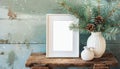 inter still life. Horizontal white frame mockup on vintage wooden bench, table. Modern white ceramic vase with pine tree branches Royalty Free Stock Photo