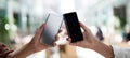 The interaction of two smartphones held by diverse hands in a modern environment. AI generated image Royalty Free Stock Photo