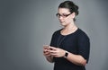 Interactive business conducted right from her phone. Studio shot of a young businesswoman using a mobile phone against a