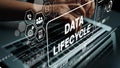 Interactive Data Lifecycle Management Concept Displayed on Laptop with Hands Typing in Background. Asymptotic smart data Royalty Free Stock Photo