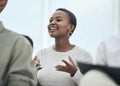 Interactive and engaging. a young woman sharing her opinion at a meeting in a modern office.