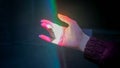 Woman moving hand under colorful laser rays - close up view - visuals concept