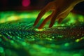 An interactive hand reaches out to touch a glowing digital interface that contains circular patterns Royalty Free Stock Photo