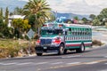 INTERAMERICANA, GUATEMALA - MARCH 22, 2016: Colourful chicken bus, former US school bus, rides on Interamericana highway