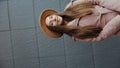 Interception portrait of Charming long hair young woman in a coat and round hat