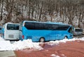 Intercity buses parked near the mountain forest at winter Royalty Free Stock Photo