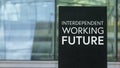 Interdependent Working Future on a sign outside a modern glass office building