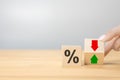 Interest rate financial and mortgage rates concept. Hand flip wood cube change arrow down to up. Wooden blocks with percentage Royalty Free Stock Photo