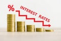 Interest rate financial and mortgage rates concept, stack of coin showing percentage decrease graph interest rates rise