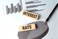 INTEREST RATE text on wooden block on chart background Royalty Free Stock Photo